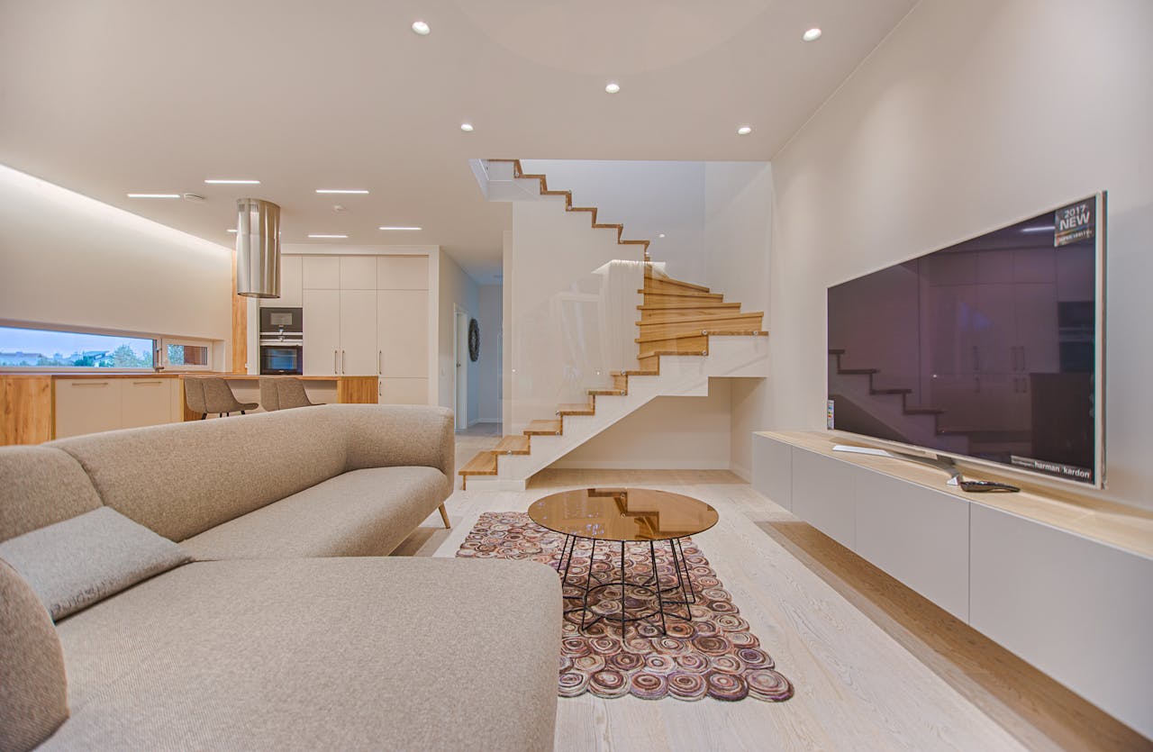 Crafting Captivating Headlines: Your awesome post title goes here Spacious modern living room featuring stairs, a TV, and sleek furniture design.